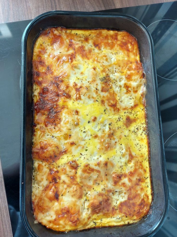 a casserole dish is sitting on the stove top, ready to be eaten