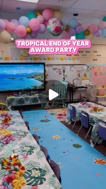 a party room with balloons and decorations on the ceiling for a tropical end of year award party