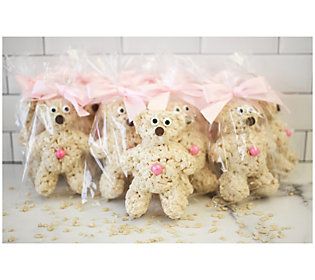 four teddy bears wrapped in plastic bags with pink bows on them, sitting next to each other