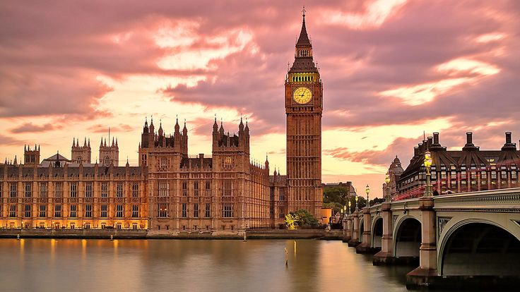 the big ben clock tower towering over the city of london, england at sunset or dawn