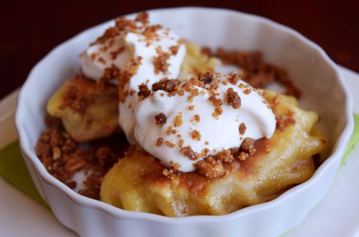 a white bowl filled with food on top of a table