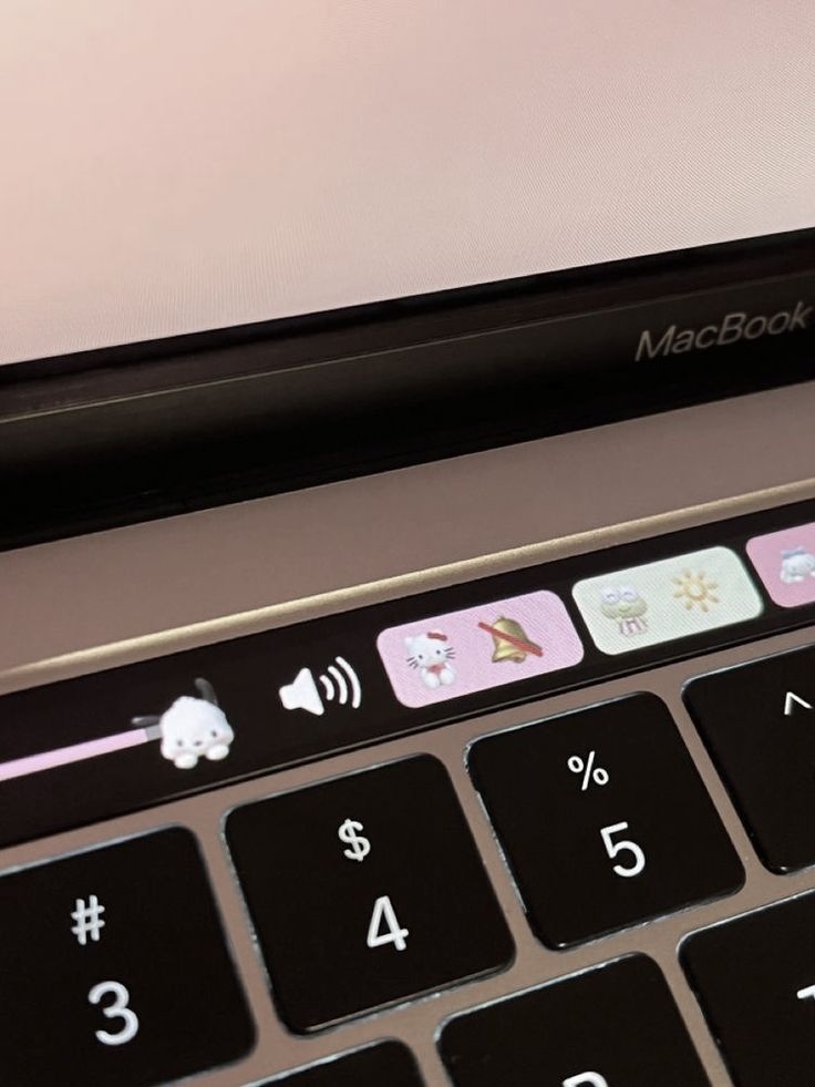 an open macbook pro laptop computer with stickers on the keyboard and mouse pad