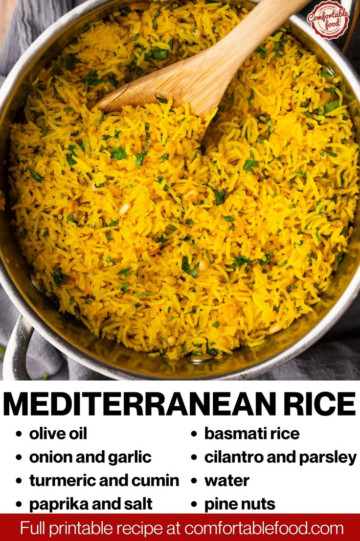 a pan filled with yellow rice next to a wooden spoon