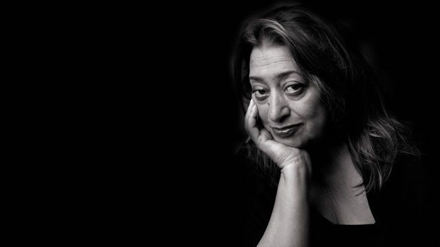 a black and white photo of a woman with her hand on her chin looking at the camera