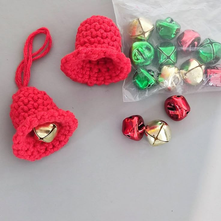 two crocheted bells and some candy wrapped in plastic