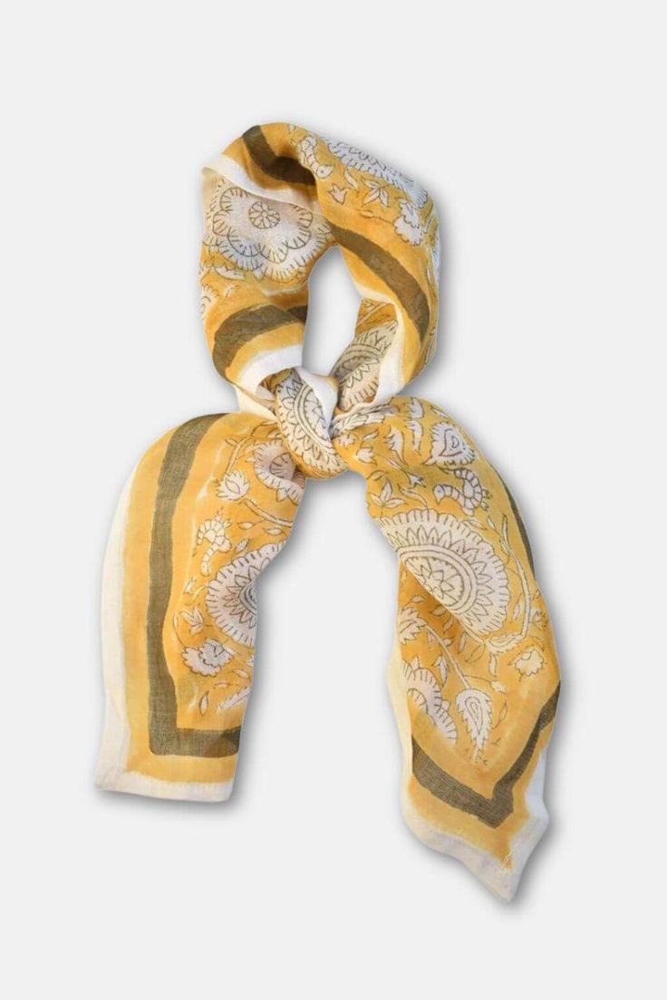 Like a ray of sunshine, the Tate Bandana brightens up any look with its cheerful, vibrant design. This delightful accessory is block printed by skilled artisans in Bagru, India, capturing the essence of traditional craftsmanship and artistic expression. The sunny hues and intricate patterns make it a versatile addition to your wardrobe, effortlessly adding a pop of color and charm to your style. Key Features: Unique Design: The Tate Bandana features bold, sunny hues and intricate patterns that a Summer Yellow Dupatta With Printed Motifs, Traditional Hand Printed Cotton Scarves, Bohemian Multicolor Block Print Scarves, Yellow Bohemian Bandana For Summer, Traditional Spring Scarves For Gifts, Traditional Spring Scarves As Gifts, Yellow Printed Cotton Dupatta, Traditional Spring Scarves For Gift, Bohemian Printed Patterned Scarves