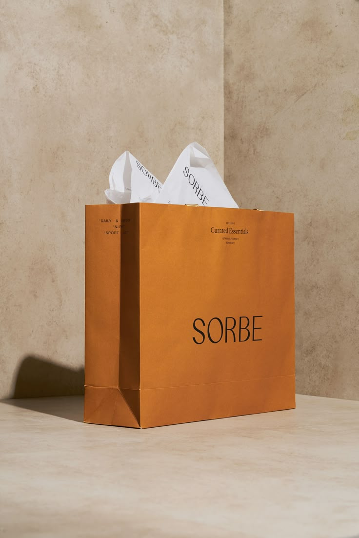 a brown paper bag with the word sorbe printed on it sitting on a table