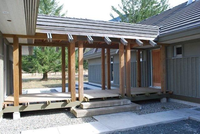 an outdoor covered patio with steps leading up to it