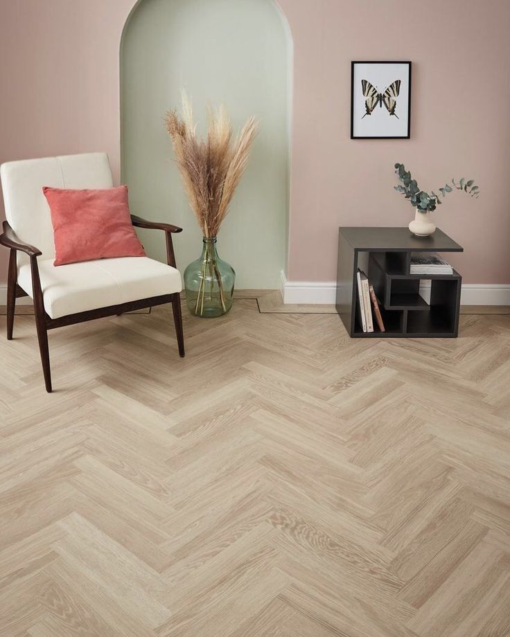 a living room with wood flooring and pink walls