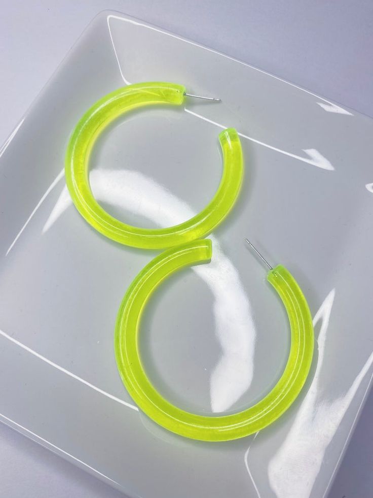 Unique and eye-catching, these earrings will make you stand out and add a fashionable touch to any style. These Transparent Hoop Earrings are perfect to dress up or down! Trendy Neon Jewelry, Trendy Yellow Plastic Earrings, Plastic Hoop Earrings For Gifts, Plastic Hoop Earrings As Gift, Plastic Hoop Earrings Gift, Green Small Hoop Earrings For Spring, Green Hoop Earrings For Spring, Green Hoop Earrings For Summer Party, Trendy Summer Hoop Earrings With Ear Wire