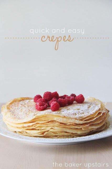 a stack of pancakes with raspberries on top