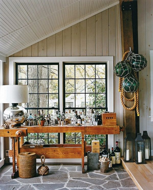 a table with bottles and baskets on it in front of a window