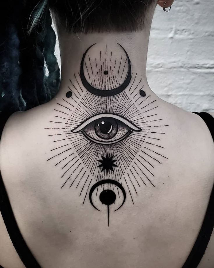 the back of a woman's neck with an all seeing eye tattoo