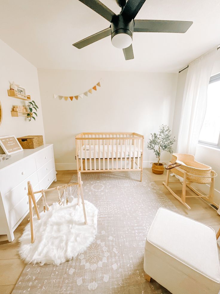 a baby's room with a crib, rocking chair and dresser in it