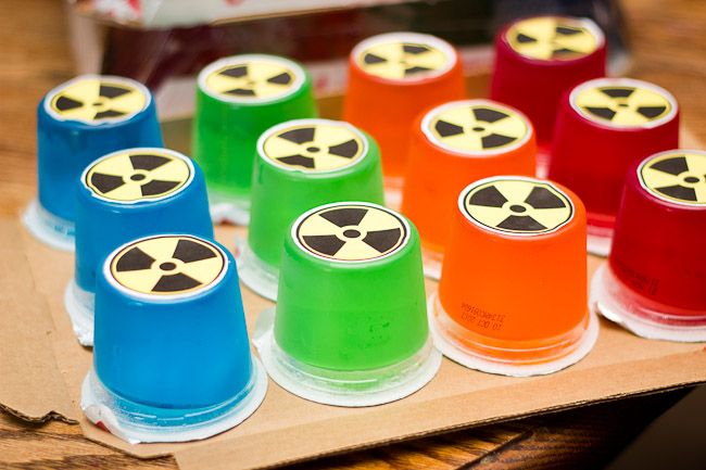 a group of colorful cups sitting on top of a wooden table