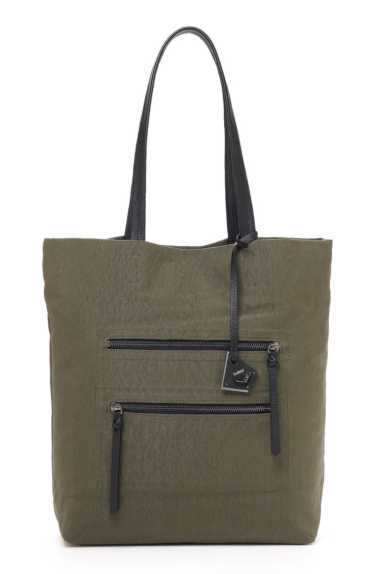 A set of soft leather shoulder straps and a slim profile ensure this sporty tote bag is a must-have for commuters and weekend warriors. 11 3/4"L x 14 1/2"H x 5 1/4"D Dual top shoulder straps Exterior has 2 front zip pockets Interior has 1 zip pocket, 1 slip pocket, 2 card slots Polyester with leather trim Imported Functional Shoulder Bag With Zipper Pocket For Shopping, Shopping Tote Hobo Bag With Zipper Pocket, Shopping Hobo Tote Bag With Zipper Pocket, Modern Satchel With Zipper Pocket For Shopping, Sporty Tote Shoulder Bag With Adjustable Strap, Sporty Shoulder Bag With Zipper Closure For On-the-go, Sporty Shoulder Bag With Zipper For On-the-go, Sporty Shoulder Bag With Double Handle And Adjustable Strap, Canvas Satchel With Zipper Pocket For Shopping