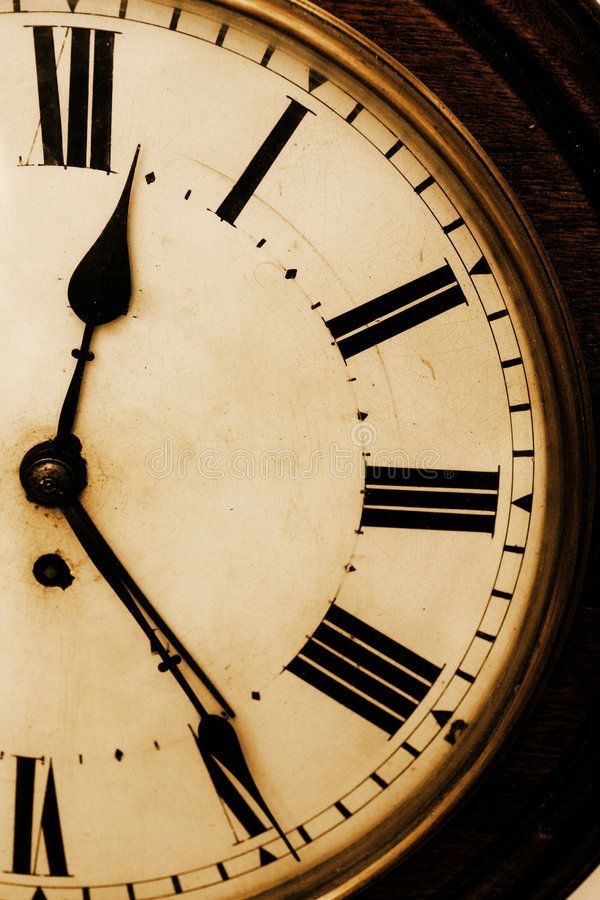 an old clock with roman numerals is shown in sepia tone stock photo