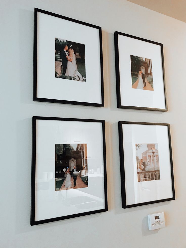 three black and white framed pictures hang on the wall next to a couple's wedding photos