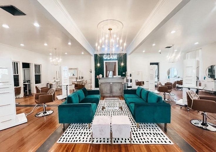 a living room filled with lots of furniture next to a hard wood floored floor