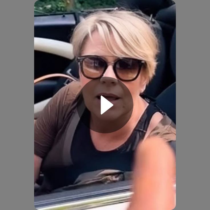 a woman in sunglasses is sitting in the back seat of a car and talking to someone