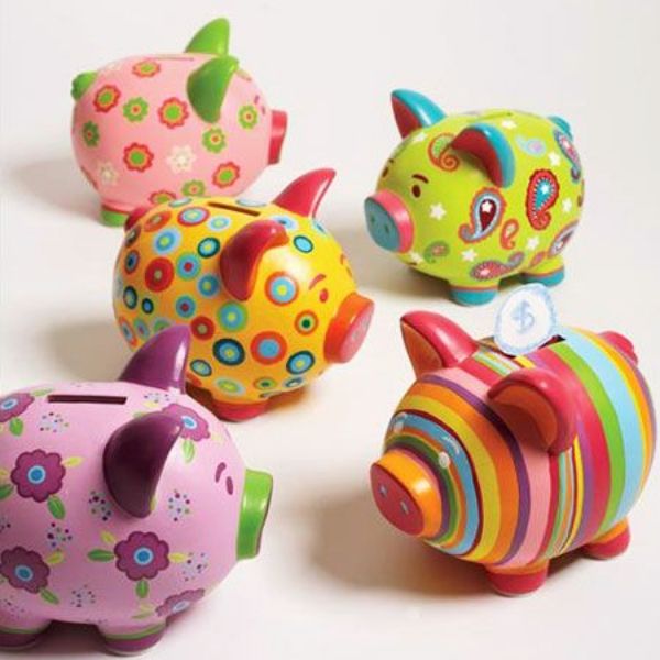 five brightly colored ceramic pig figurines sitting next to each other on a white surface