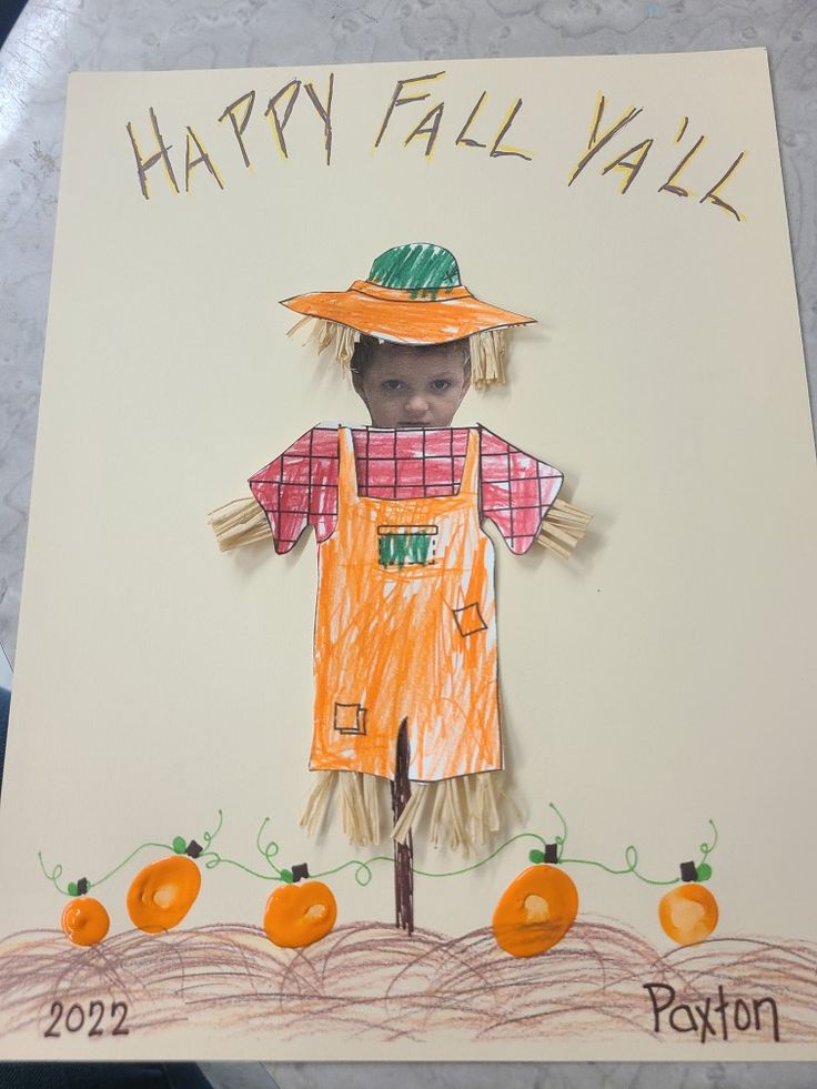 a child's drawing of a scarecrow with pumpkins