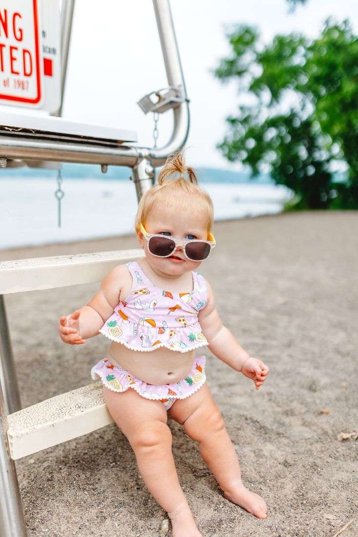 Take the poolside party everywhere you go with this dreamy two-piece tankini set! From its UPF 50+ sun protection to its ruffle details, this outfit will keep your little one comfy and cool as a cucumber all summer long (and look good doing it!). Get your P.O.O.L.S.I.D.E. on! All new and girlie Dream Tankini Two Piece Swim Suit! Made with comfort and stretch in mind, this eye-catching suit features a pom-pom trim and ruffled top and bottom for maximum style and beach-loving vibes. Our UPF 50+ sw Playful Swim Trunks For Spring Beach, Playful Fitted Swim Trunks For Vacation, Playful Swim Trunks For Spring Pool Occasion, Playful Ruffled Swimwear For Summer, Fitted Summer Playwear Tankini, Playful Swim Trunks For Vacation In Spring, Cute Swimwear With Uv Protection For Vacation, Playful Swim Trunks For Beach Season Vacation, Cute Ruffled Swimwear For Vacation