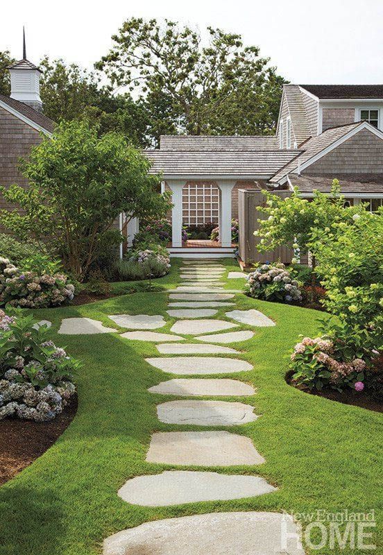 a stone path in front of a house