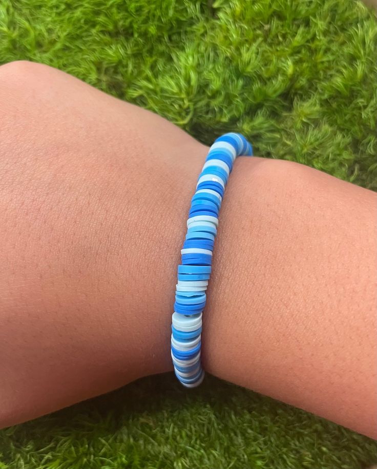 The perfect kids bracelet made with white and blue clay beads Clay Bead Blue Bracelet Ideas, Blue Heart Beads Friendship Bracelets For Beach, Casual White Polymer Clay Beaded Bracelets, Blue Clay Bracelet Ideas, Casual White Beaded Bracelets With Polymer Clay, Casual White Polymer Clay Bracelets, Everyday White Polymer Clay Bracelets, White Polymer Clay Beaded Bracelets, White Polymer Clay Beaded Bracelets With Round Beads