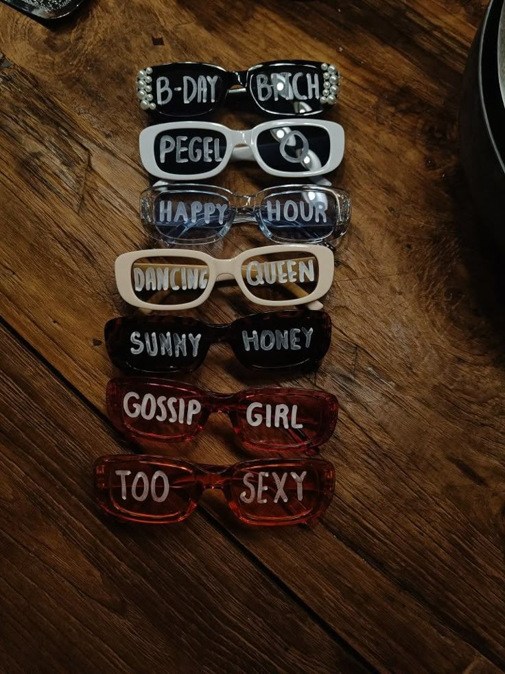 six pairs of sunglasses with different sayings on them