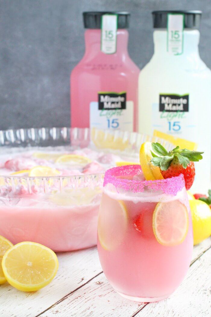 two glasses filled with pink lemonade and strawberries