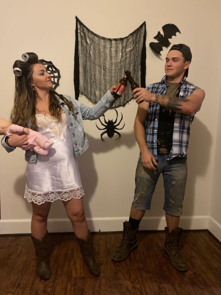 a man and woman dressed up in halloween costumes, standing next to each other holding scissors