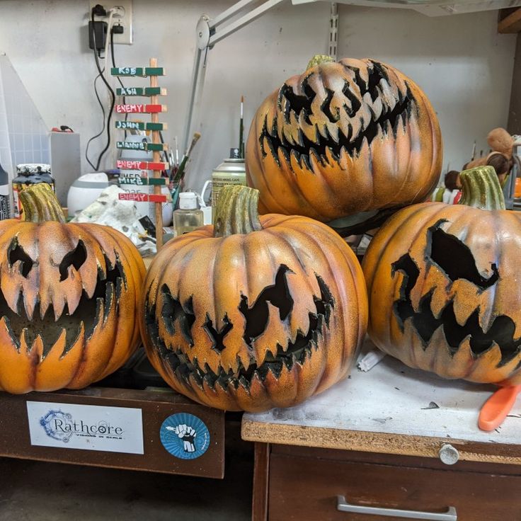 pumpkins with carved faces and bats on them