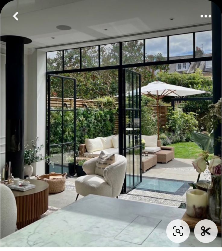 a living room filled with furniture and an open glass door