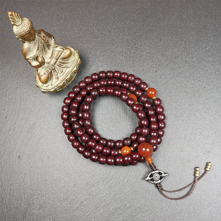 ❤This mala is made by Tibetan craftsmen and come from Hepo Town, Baiyu County,Tibet, the birthplace of the famous Tibetan handicrafts.It's composed of 108 pcs 9mm lotus seed beads,with agate spacer beads,and agate bead counters,diameter 0.35",circumference 35".❤Details:Mala'perimeter is 88cm,35 inches.108 lutus seed beads approximately 9mm / 0.35 inch.1 × agate main bead,diameter 12mm × 10mm / 0.47 × 0.4 inch.2 × agate spacer beads diameter 10mm / 0.4 inch.1 × agate guru bead,22mm × 13mm / 0.87 Traditional Jewelry For Meditation With 8mm Beads, Traditional 8mm Beads Jewelry For Meditation, Traditional Jewelry With 8mm Beads For Meditation, Handmade Round Spiritual Mala, Traditional Handmade Mala For Meditation, Handmade Spiritual Round Mala, Traditional Wooden Beads Mala As Gift, Handmade Spiritual Round Beads, Traditional Handmade Beaded Bracelets For Meditation