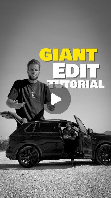 a man standing next to a black car with the words giant editt on it