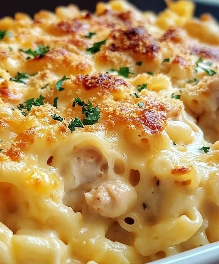 macaroni and cheese with parsley in a white dish