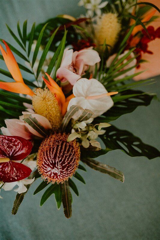 an arrangement of flowers is displayed on a table