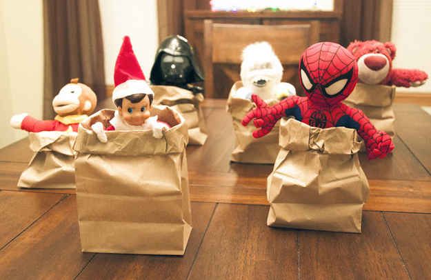 there are three small bags with toys in them on the table, one has a spiderman figure