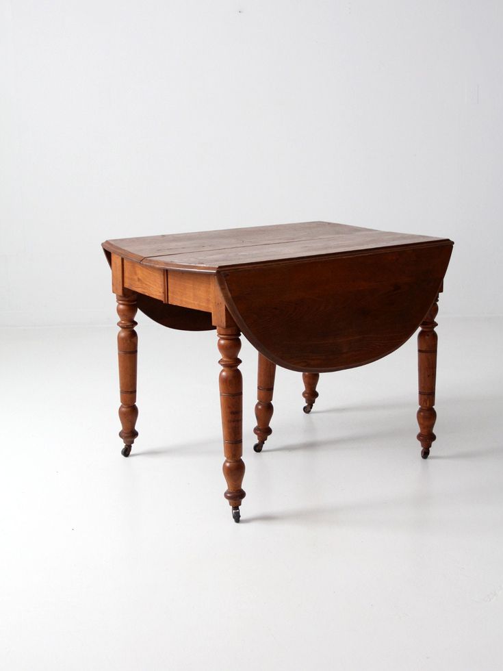 a small wooden table with one drawer on the top and two legs at the bottom