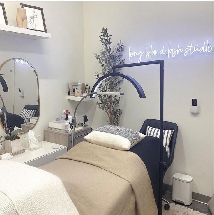 a bed room with a neatly made bed and two round mirrors on the wall above it