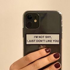 a woman's hand holding an iphone case with the text i'm not shy, i just don't like you