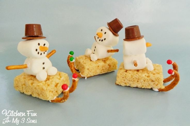 three snowmen made out of rice krispy kreme treats sitting on top of each other