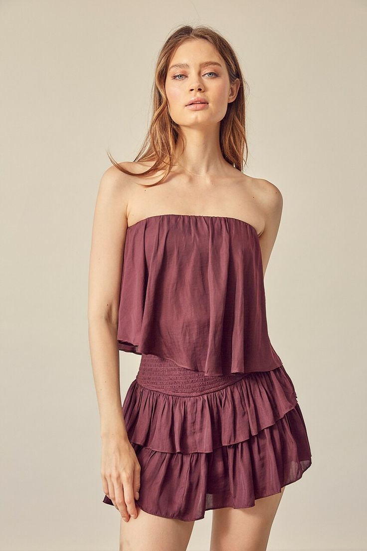 Burgundy Strapless Ruffle Overlay Romper Chic Flowy Strapless Dress, Chic Flowy Strapless Maxi Dress, Chic Strapless Flowy Maxi Dress, Flowy Strapless Maxi Dress, Chic Strapless Ruffled Tube Top, Off-shoulder Ruffled Tube Top For Day Out, Chic Strapless Tube Top With Ruffles, Strapless Ruffles Tube Top For Beach, Ruffled Strapless Tube Top For Brunch