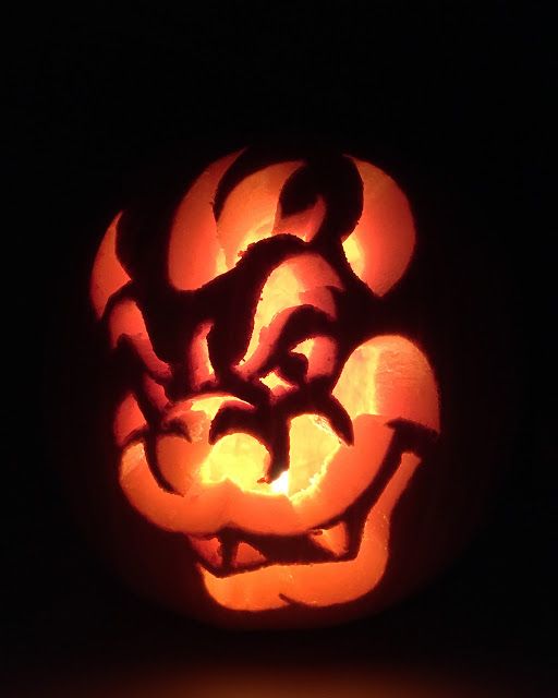 a carved pumpkin with an evil face on it