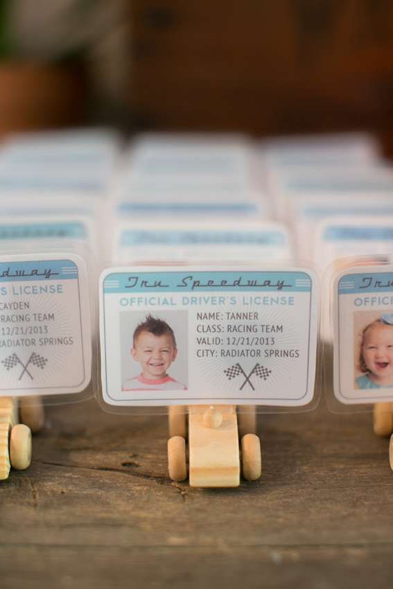 small wooden pegs holding business cards on top of a table with stickers attached to them