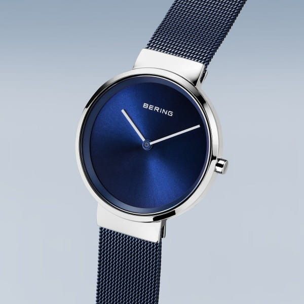 Classic, puristic, and yet exciting. Perfect style combined with contemporary minimalism. Inspired by Danish design, the CLASSIC COLLECTION represents a unique timepiece, perfectly highlighting your daily style.  The polished silver colored stainless steel case, made of pure, high quality, medical-grade stainless steel (316L), in combination with the modern blue colored milanese strap, provides the classic BERING look. The fine workmanship of the milanese strap gives the watch a refined, almost Modern Business Watches, Modern Stainless Steel Watches, Minimalist Stainless Steel Watch For Formal Occasions, Modern Stainless Steel Round Watches, Modern White Gold Watches With Analog Display, Modern White Gold Watch With Analog Display, Silver Minimalist Watch For Formal Occasions, Modern Silver Watch For Everyday Wear, Silver Everyday Watch With Polished Finish