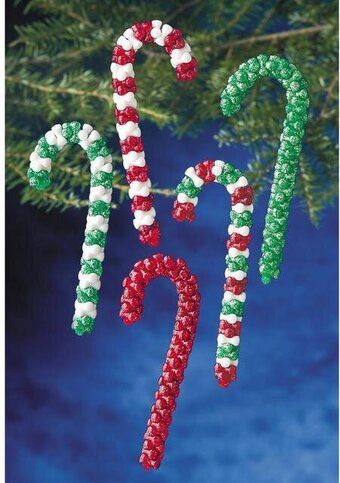 two candy canes hanging from a christmas tree