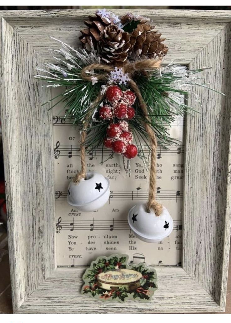 an old frame is decorated with christmas decorations and pineconis, while other ornaments are hung on the wall