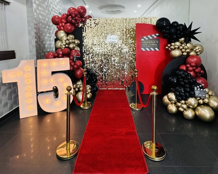 a red carpeted hallway with gold and black decorations on the wall, and a number 15 sign